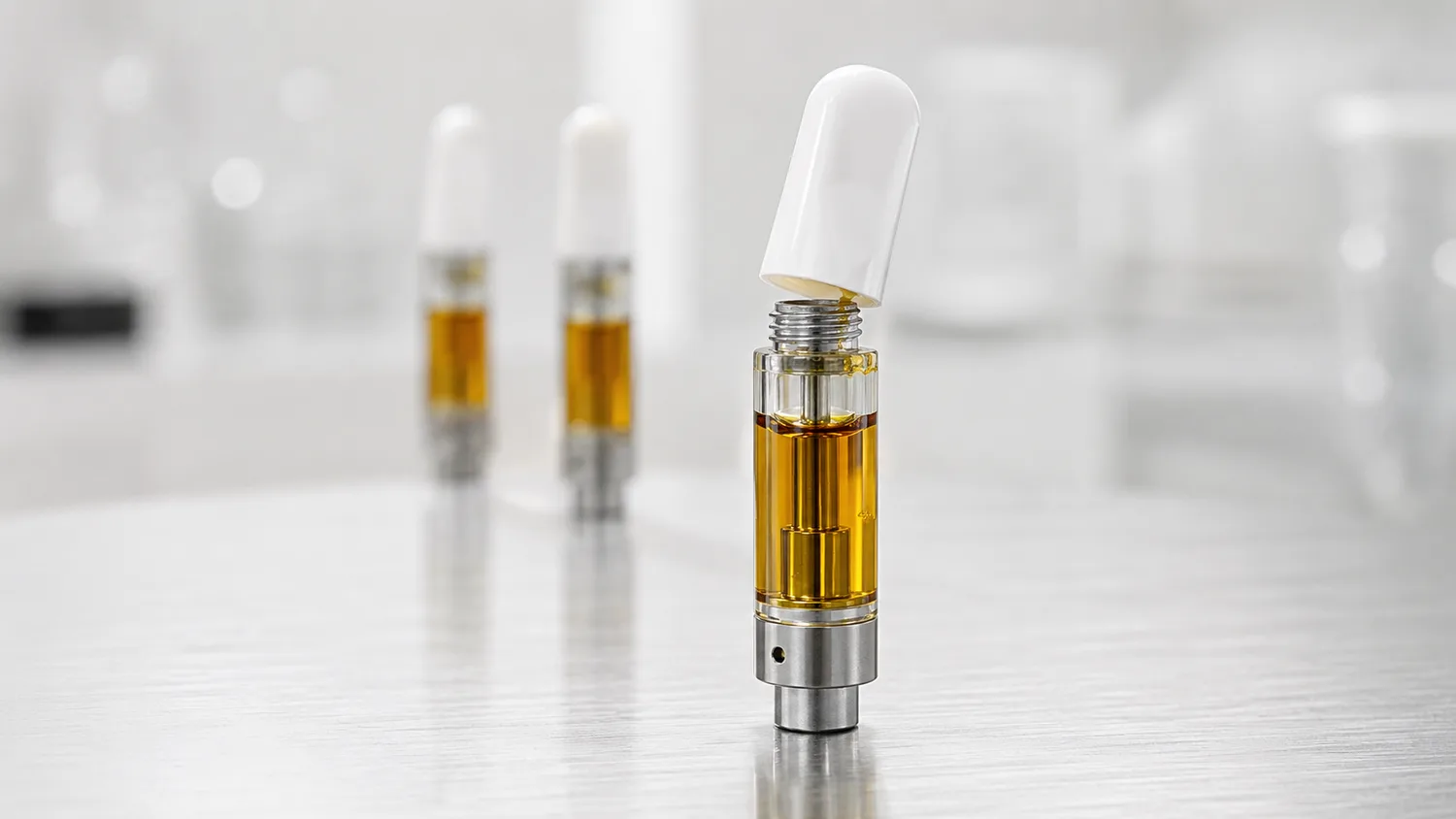 Close-up of a vape cartridge with a tightly seated cap to prevent loose caps and leaks